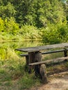 Old table and bench for travelers on the river bank Royalty Free Stock Photo