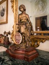 Old table clock with golden statue of a female figure.