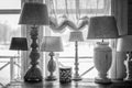 old table lamp standing on the table, carved legs, lots of lamps, a vintage bw