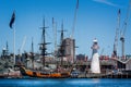 Old Tall Ship moored in Darling Harbour alongside white lighthouse in Sydney, NSW, Australia Royalty Free Stock Photo