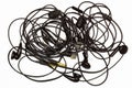 Old tangled headphones on a white background. Isolated. Black dusty dirty wired headphones with tangled wires. Audio Speakers