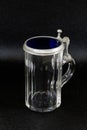 an old tankard of glas with a tin lid against a black background Royalty Free Stock Photo