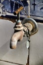 Old Tap with rosary beads in blessed fountain