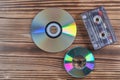 Old tape and disk recording on a wooden table Royalty Free Stock Photo