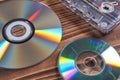 Old tape and disk recording on a wooden table Royalty Free Stock Photo