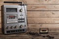 the old tape recorder and cassette on wooden background Royalty Free Stock Photo