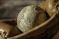 Old tattered baseball in leather baseball glove Royalty Free Stock Photo