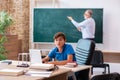 Old male teacher and schoolboy in the classroom