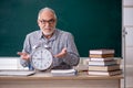 Old male teacher in time management concept Royalty Free Stock Photo