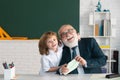 Old teacher and young schoolboy. Kids learning science. Teachers day. Royalty Free Stock Photo