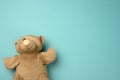 Old teddy bear with a band-aid on the eye lies on a blue background Royalty Free Stock Photo