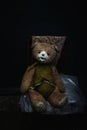 Old Teddy bear sitting in abandoned house Royalty Free Stock Photo