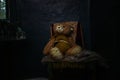 Old Teddy bear sitting in abandoned house Royalty Free Stock Photo