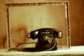 An old telephone in an ancient frame Royalty Free Stock Photo