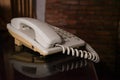 Old telephone in brick wall house. Royalty Free Stock Photo