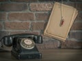 Old telephone and paper with pencil Royalty Free Stock Photo