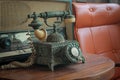 Old telephone retro rotary phone antique style in vintage room Royalty Free Stock Photo