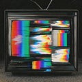 Old television set displaying colorful static and signal issues Royalty Free Stock Photo