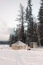 An old tent in the snow. A tent with a stove inside among the taiga Royalty Free Stock Photo