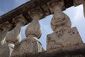 Old terrace balusters made of stone or concrete against blue sky. Abstract classical architecture exterior fragment.