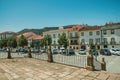 Old terraced houses in a deserted square with cars