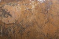 Old terracotta color concrete wall with white paint markings and black scratches background texture