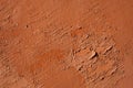 Old terracotta painted stucco wall with chipped paint. Background texture