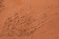 Old terracotta painted stucco wall with chipped paint. Background texture