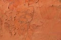 Old terracotta painted stucco wall with chipped paint. Background texture Royalty Free Stock Photo