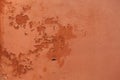 Old terracotta painted stucco wall with chipped paint. Background texture Royalty Free Stock Photo