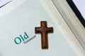 Old testament cover in Holy Bible with a wooden cross