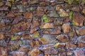 Old texture of stacked stone wall have bright green moss along the rock Royalty Free Stock Photo
