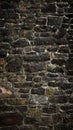 old texture stone wall. dark gray creative backdrop made of ancient boulders. vertical format 9x16