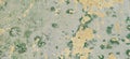 Old textured concrete wall background. Wall fragment with scratches and cracks in gray, beige, green colors Royalty Free Stock Photo