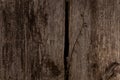 Old textured dark wood surface with cracks, knots, rusty nail. Fragment of fence or natural background of larch planks Royalty Free Stock Photo