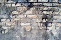 Old textured wall of white brick and cracked plaster with cracks, chips and streaks.Abstract vintage background. Royalty Free Stock Photo