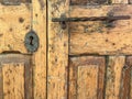 Old textured wooden door with rusty key lock hole and handle