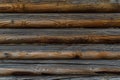Old textured wooden orange brown gray wall of round logs. Russian style Royalty Free Stock Photo