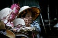 Old Thai woman Selling hats at Damnoen Saduak Floating Market.