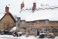 Old thatched public house in the snow.