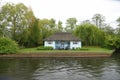 Historic cottage by English river Royalty Free Stock Photo