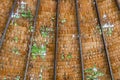 The old thatched roof leaked holes and was damaged by the storm..View of natural thatched roof with hole. The ceiling of old Royalty Free Stock Photo
