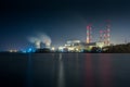 Old thermal 450 megawatt power plant at night with artificial lake on foreground Royalty Free Stock Photo