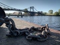 old thick anchor chain lies on the harbour wall Royalty Free Stock Photo