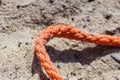 Old thick nautical rope on the sand ground . Royalty Free Stock Photo