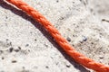 Old thick nautical rope on the sand ground . Royalty Free Stock Photo