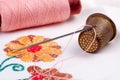 Old thimble and needle with thread Royalty Free Stock Photo