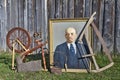 Old things near barn, portrait of Lenin, spinning wheel, handsaw