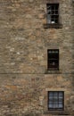Old Three windows building on Brick Wall Royalty Free Stock Photo