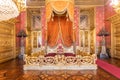 Old throne room interior with chair in luxury palace. Red and gold antique Baroque style